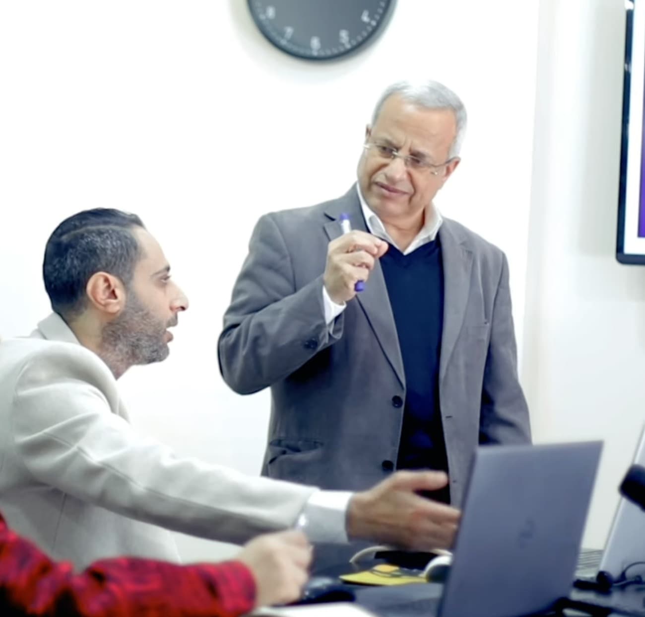 AAA assessors discussing an assessment together over a laptop