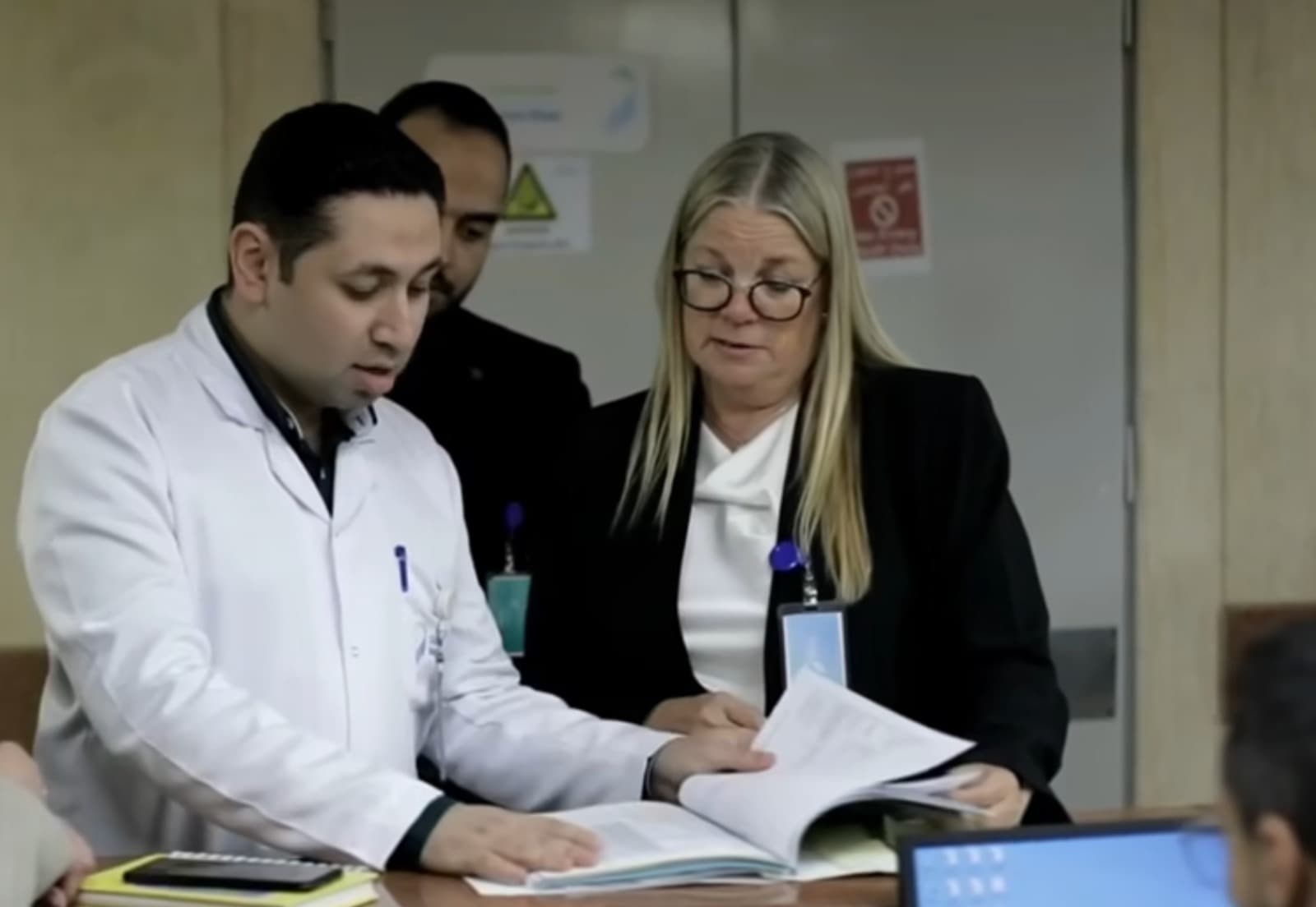 AAA assessors reviewing accreditation documents with an organisation's team